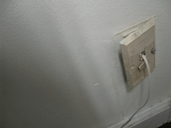 image of a broken phone jack in a hotel with poor reviews from TripAdvisor